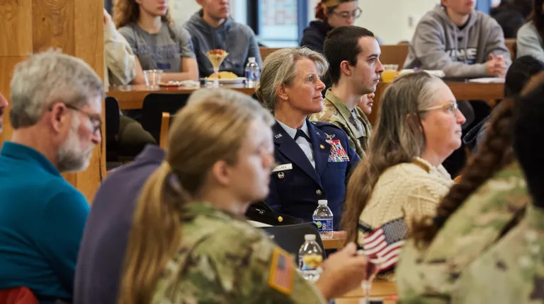 Attendees gather at a table