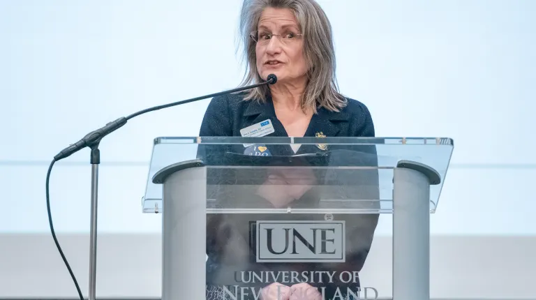 UNE College of Osteopathic Medicine dean Jane Carreiro speaks at the podium