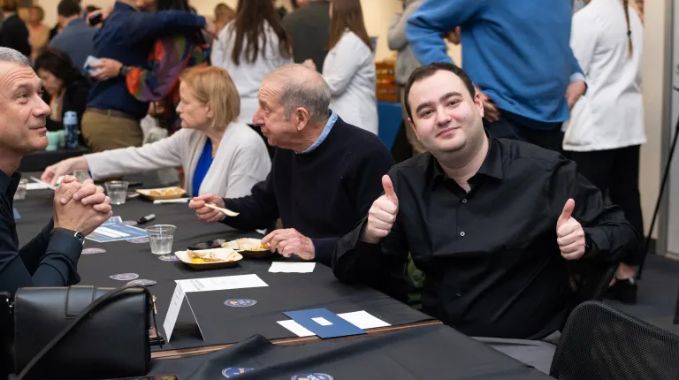 A male student gives two 'thumbs ups' while celebrating Match Day