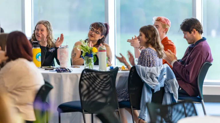 The audience applauds the inductees