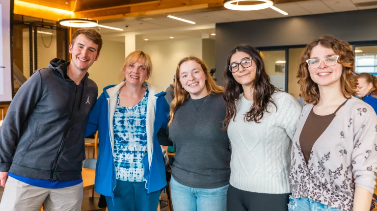 A group of students pose with UNE First Lady Lynn Brandsma