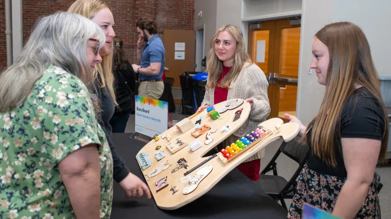 People observe a sensory board