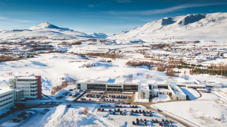 A university campus and surrounding mountains covered in snow