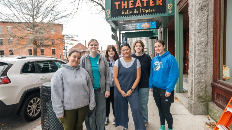 UNE students help to decorate Biddeford with lights.