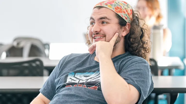 A UNE student smiles during classroom discussion