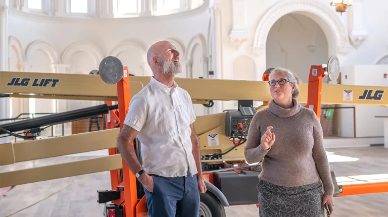 Brad Favreau and Alethea Cariddi staning infront of renovation equipment in the Biddeford community center