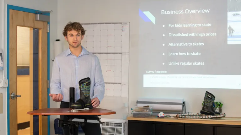 A student presents a prototype of an ice skating device