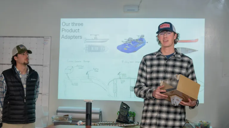 A student presents a prototype of a fishing rod stabilizer
