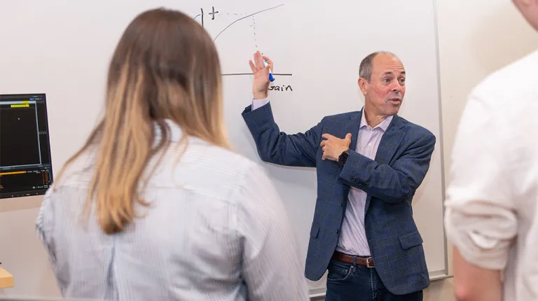 John Austin, Ph.D., P.D. Merrill Endowed Chair of Business Associate Professor lecturing to a group of business students