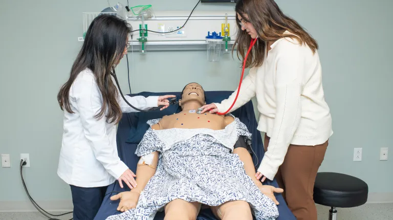 two students checking vitals together