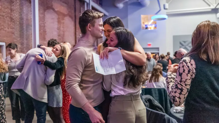 A group of medical students in a group hug