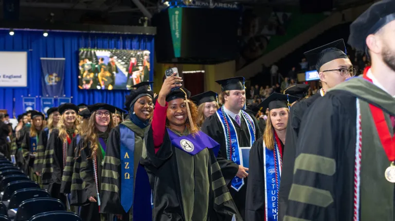 Graduates cheer as they leave the ceremony