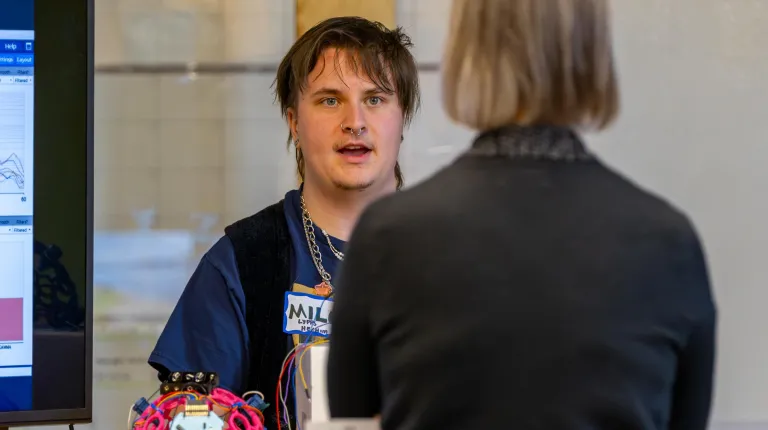 A student talks with an event attendee