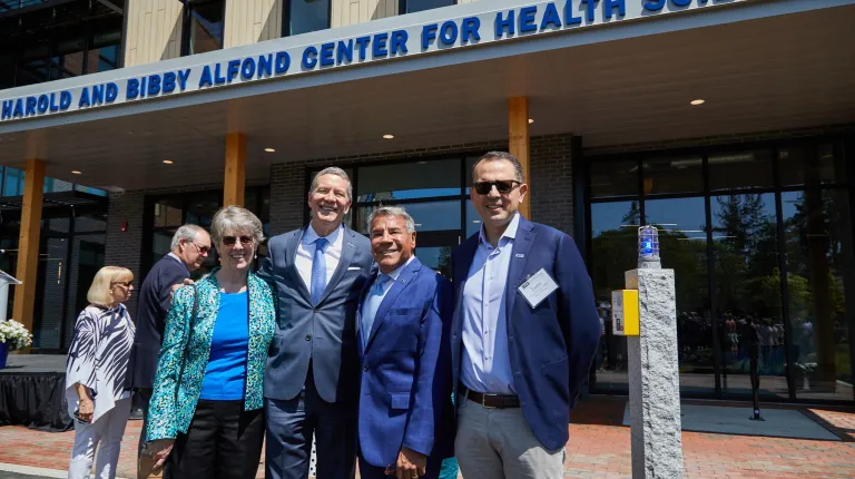 UNE President James Herbert poses with UNE benefactors