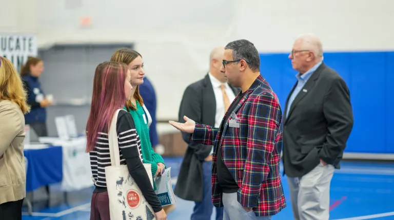 UNE professor Amir Mousavian meets with students