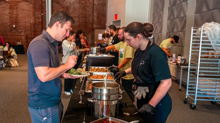 A Parkhurst employee serves a lunch guest