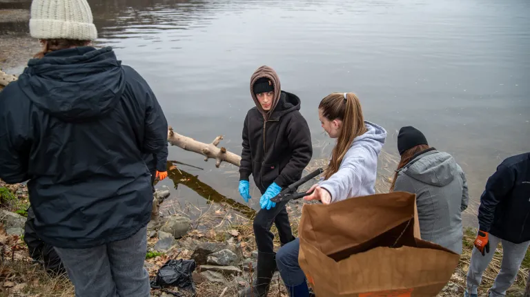 UNE students clean up debris from the shore