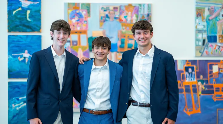 Three male students pose for a photo