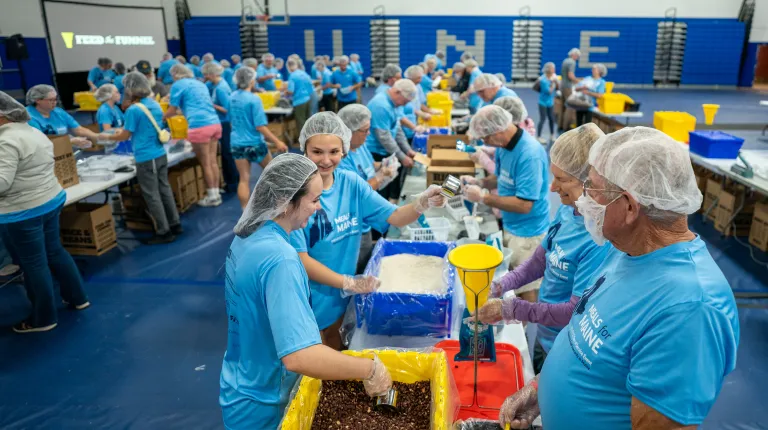 UNE, community volunteers pack a record 200,000 meal kits to combat hunger across Maine