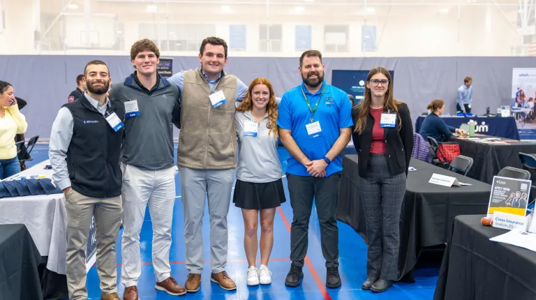 Alumni post for a photo at 2026 Industry Exploration Day