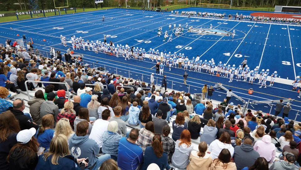 Crowd watching a U N E football game