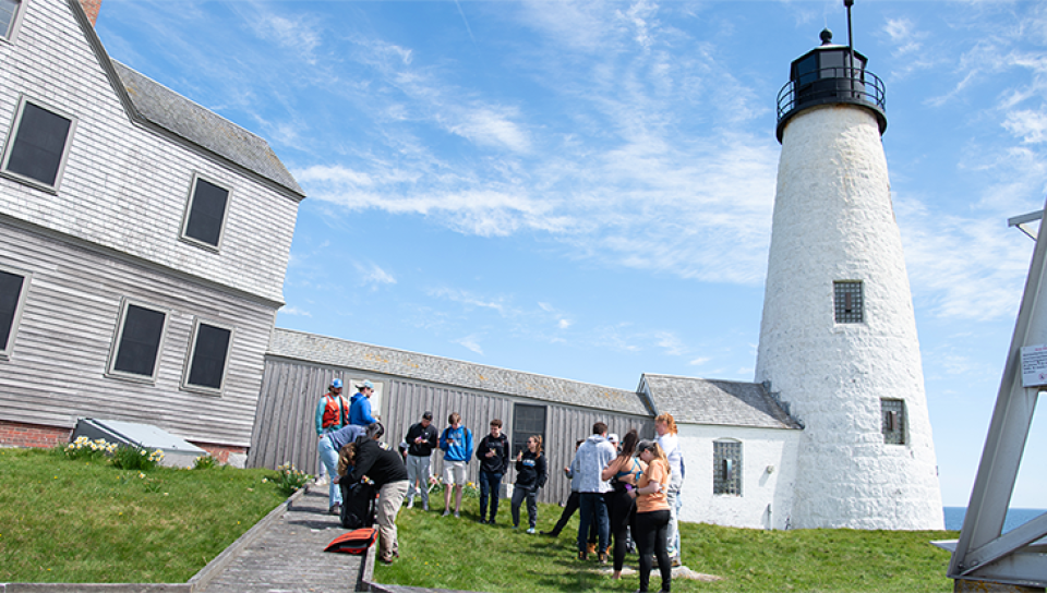 Students gather at the base of Wood Island Light