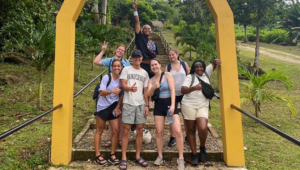 A group of PT students poses at the entrance to the Nim Li Punit ruins
