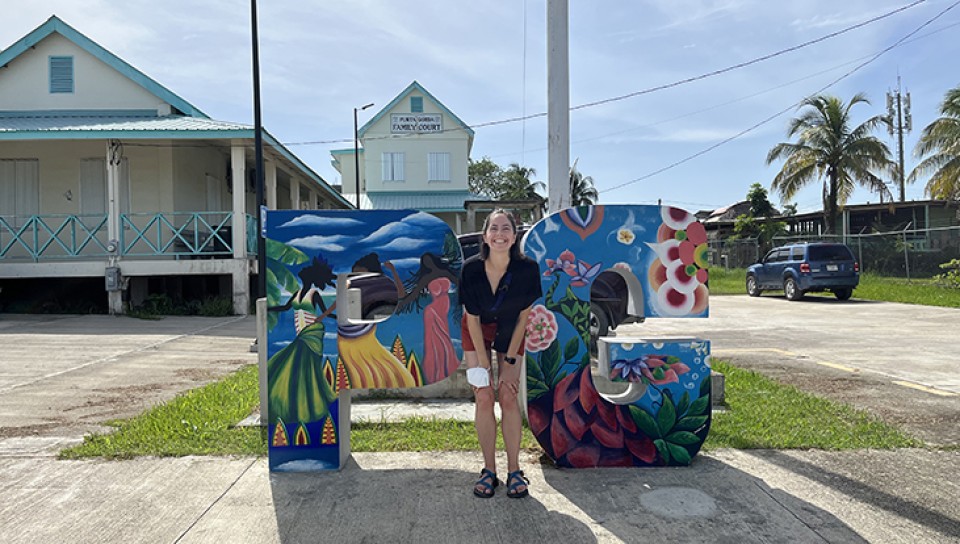 Celia poses in front of a giant set of the letters "PG," for Punta Gorda