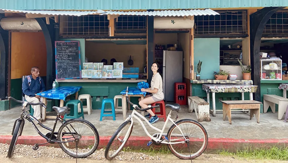 Celia Larson sits at a cafe table outside