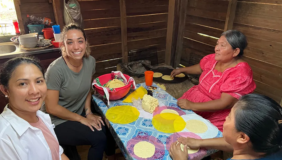 Ana Maria Castellanos makes tortillas with Kekchi Mayan women
