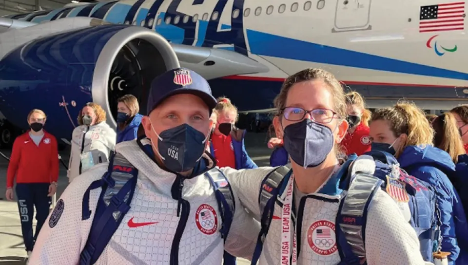 Wayne Lamarre standing with an individual in front of a USA-branded airplane