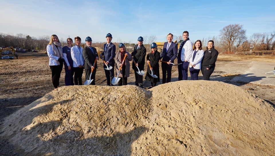 UNE leadership dig into the earth at the groundbreaking ceremony for the Harold and Bibby Center for Health Sciences on Tuesday, Nov. 29, 2022