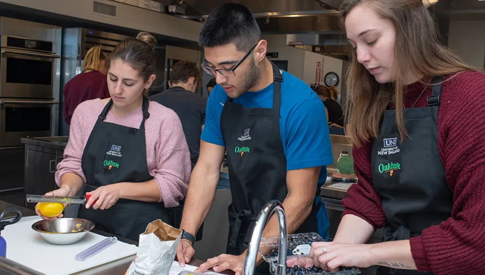 Three nutrition students preparing food