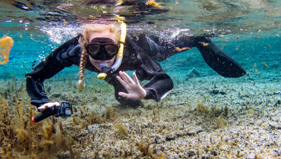A student snorkels in Icelandic water