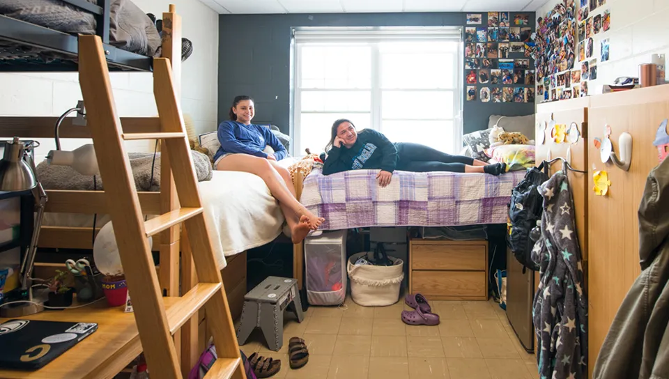 Two students hanging out in their dorm room