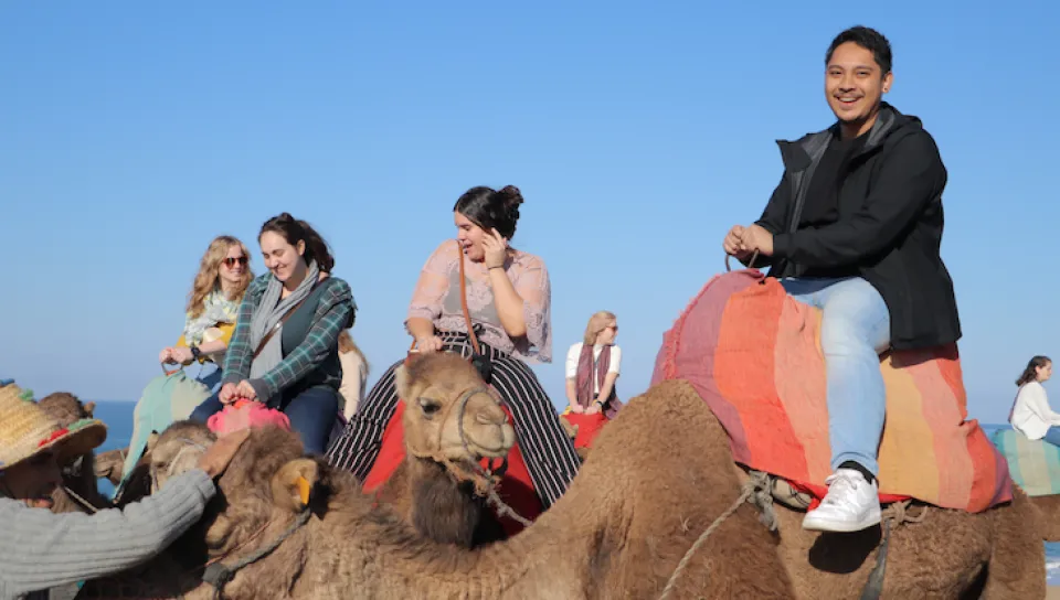 Photo of students riding camels in Morocco