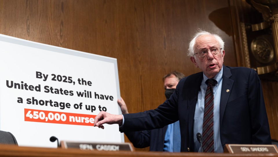 Sen. Bernie Sanders points to a board outlining a looming nursing shortage