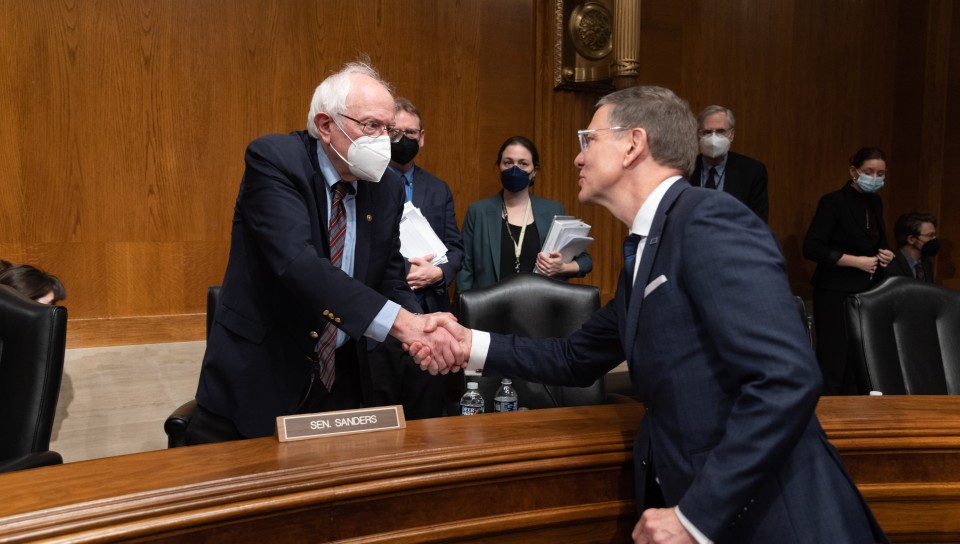 UNE President James Herbert shakes Sen. Sanders' hand following testimony