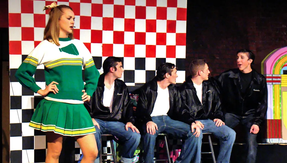 U N E Players performing a song from the play "Grease"