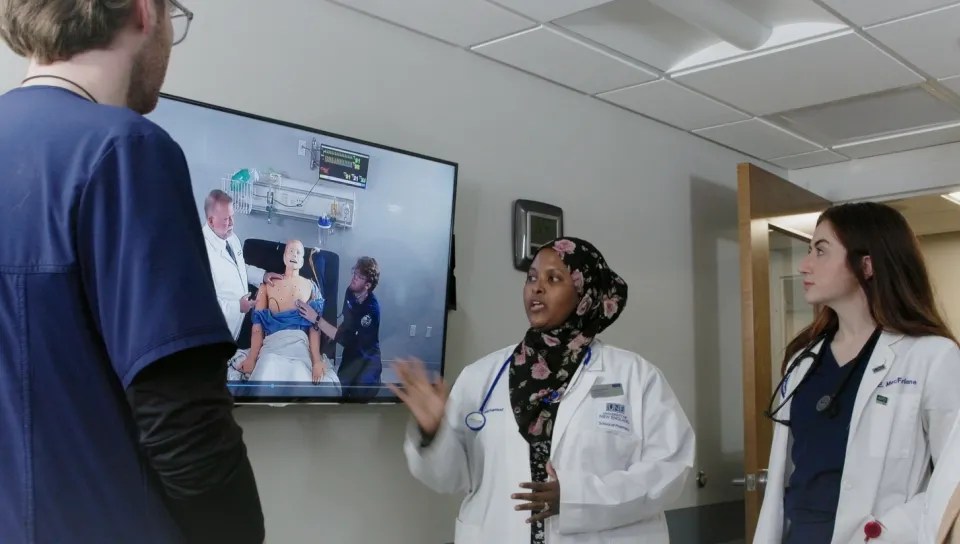 A group of health students viewing a monitor screen