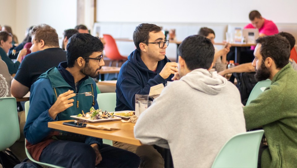 A group of students eating in the Commons dining room