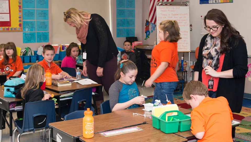 Two education majors working in an elementary school classroom