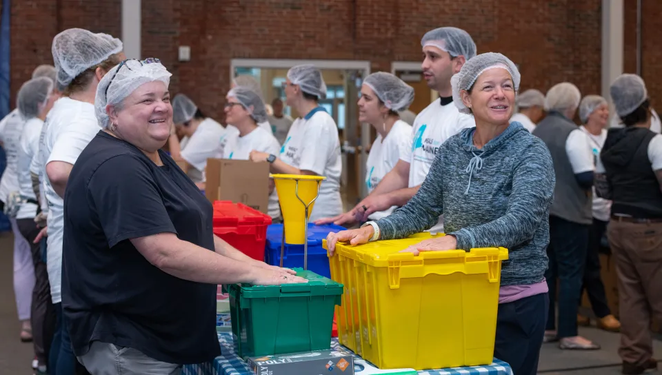 UNE faculty pack meals at the Meals for Maine event