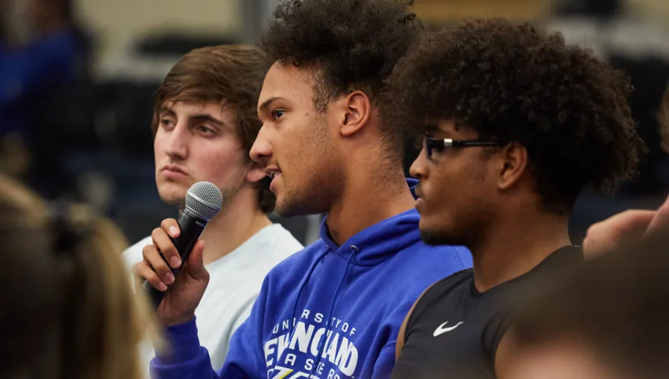 A student in the crowd makes a comment during an Intersectionality Speaker lecture