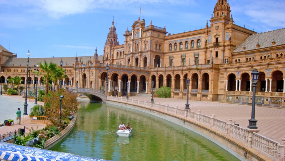Scenic view of boat on canal with building in background