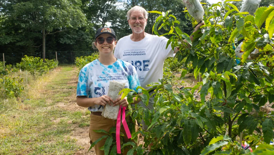 Virginia May and Tom Klak work in the experimental orchard.