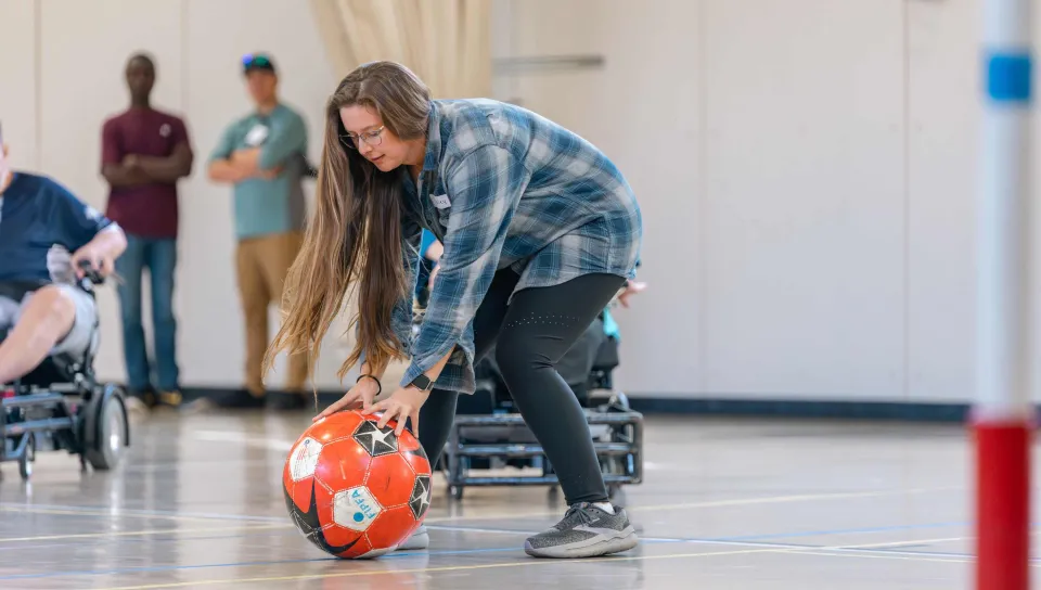 A UNE student captures a stray soccer ball