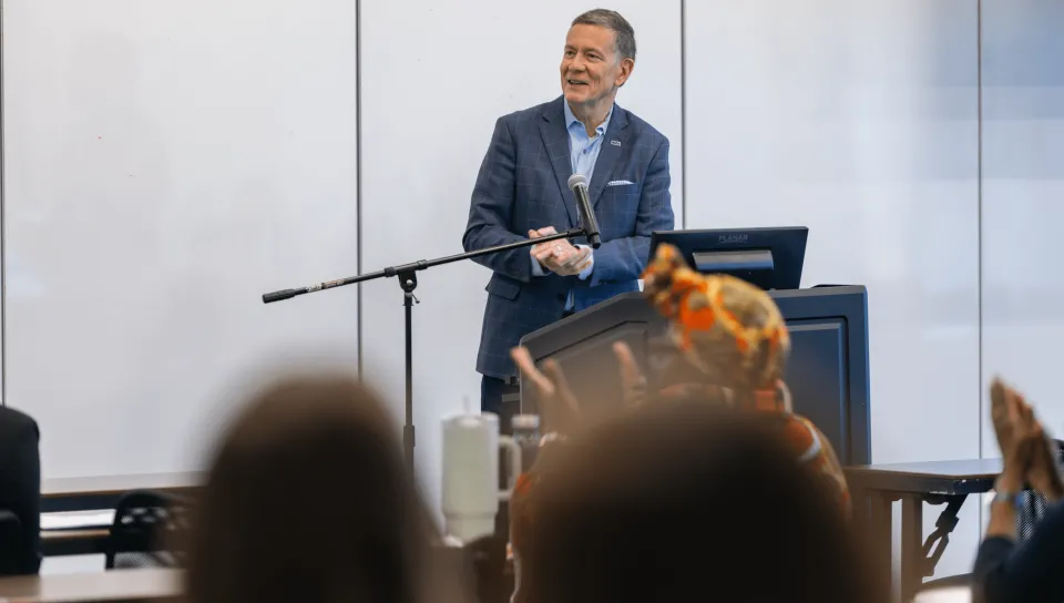 UNE President James Herbert speaks at the podium