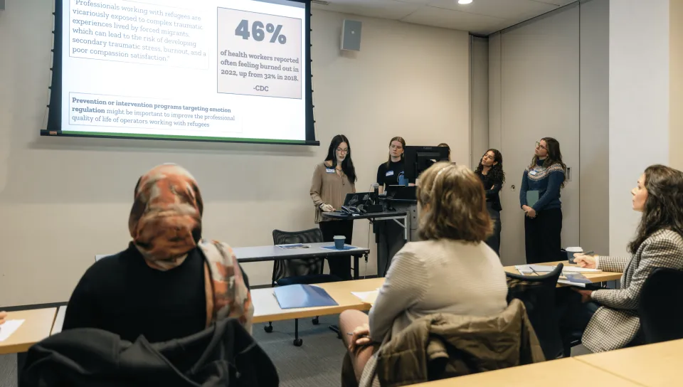 A group of students gives a slideshow presentation