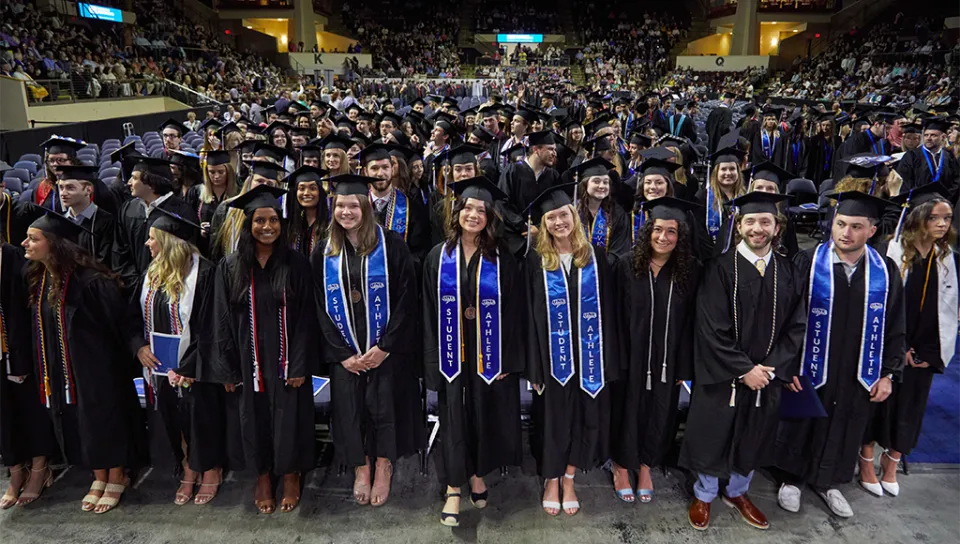 The U N E Class of 2024 group photo from the commencement stage